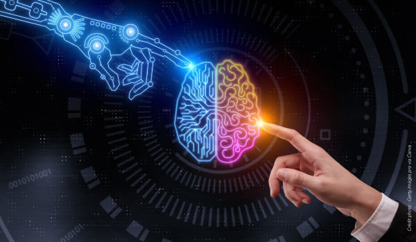 Main de robot et main humaine touchent un cerveau séparée en deux partie pour illustrer l'utilisation de l'Intelligence Artificielle